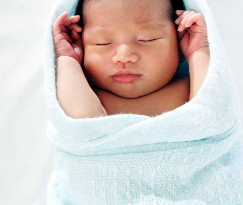 A sleeping newborn baby is calm and swaddled. Labor doula, postpartum doula, placenta encapsulation, childbirth education in DC, Silver Spring, Takoma Park, Waldorf, Brandywine, District Heights, Clinton, Alexandria and Upper Marlboro