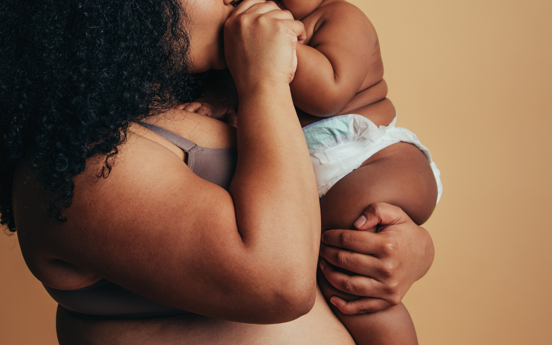 plus size new Black mom holds baby after plus size pregnancy